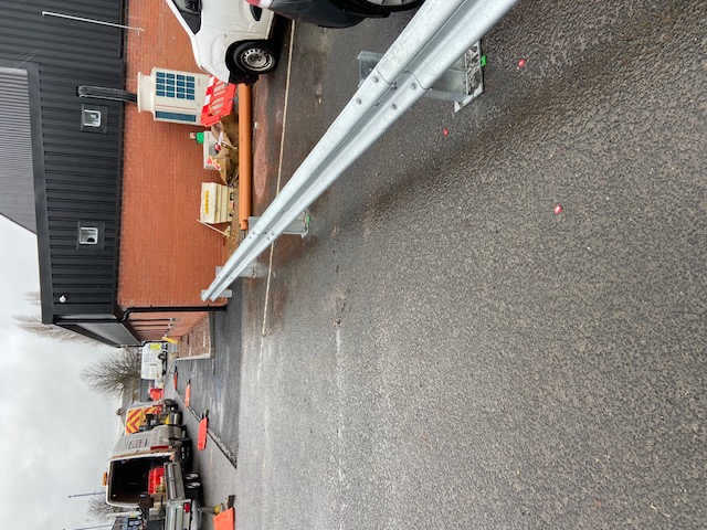 Armco barrier run beside an industrial building