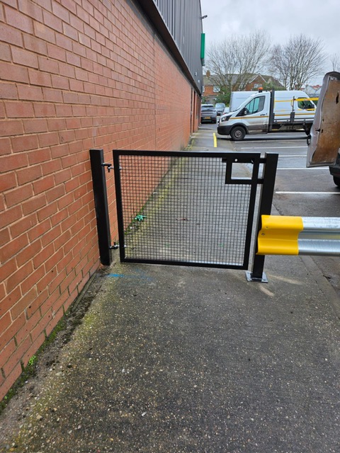 Pedestrian gate beside a commercial building