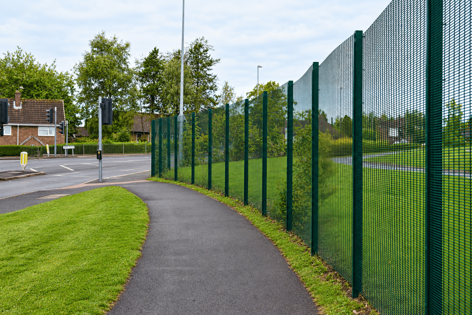 Suburban Footpath Along Green Security Fence Suburban Footpath Along Green Security Fence