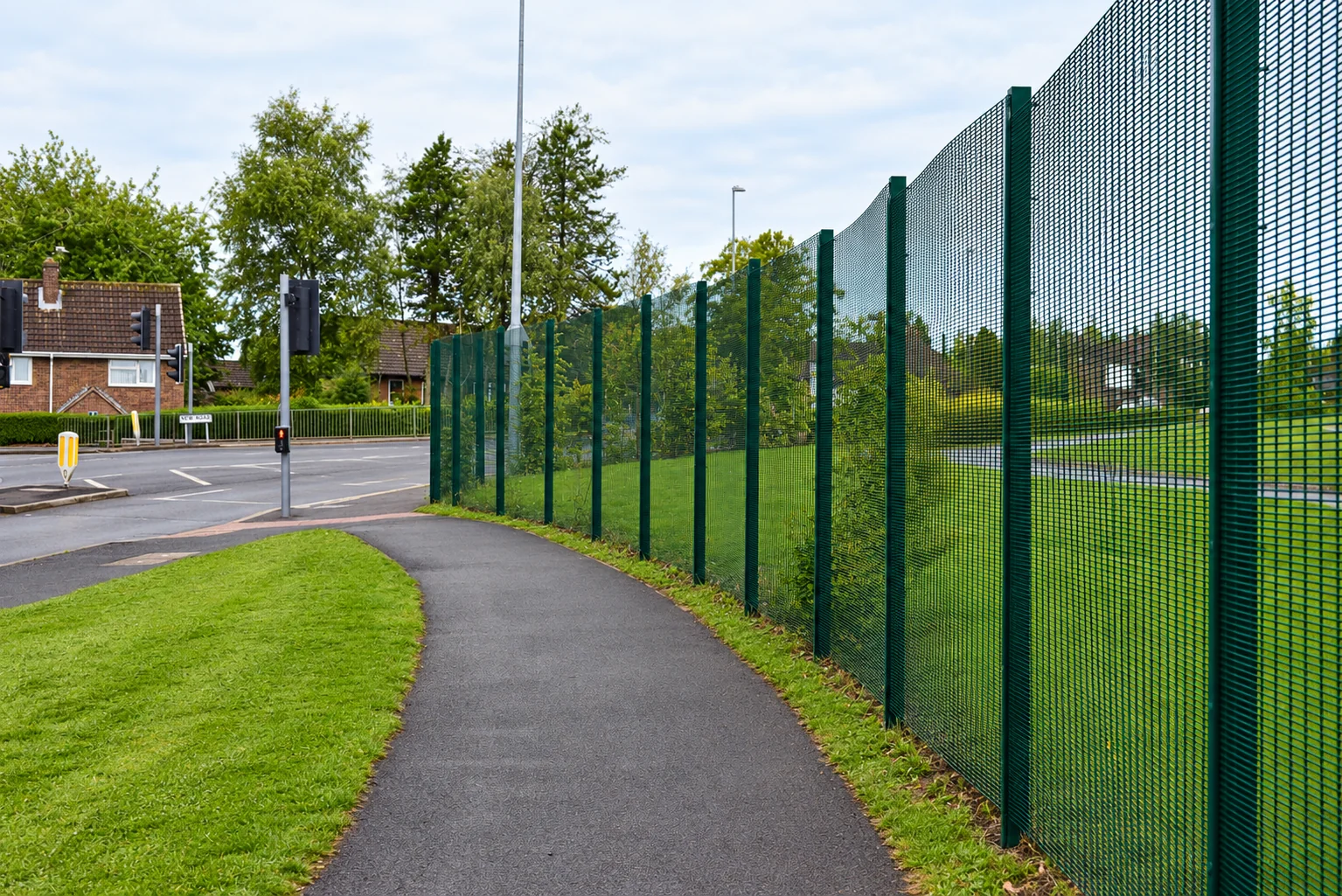 Suburban Footpath Along Green Security Fence